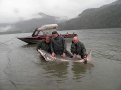 На заднем фоне лодка с которой ловили